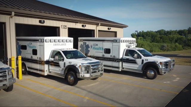 Fleet of ambulances parked in front of a garage in Montevideo, MN.